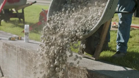Dumping foundation base out of wheel barrel Stock-Footage 255856673