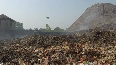Dumping garbage emitting methane gas polluting atmosphere Stock Footage 221908509