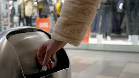 Dumping trash in a trash can in a shopping center Stock Footage 143265823