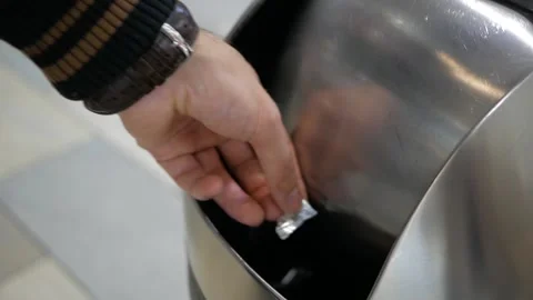Dumping trash in a trash can in a shopping center Stock Footage 143265852