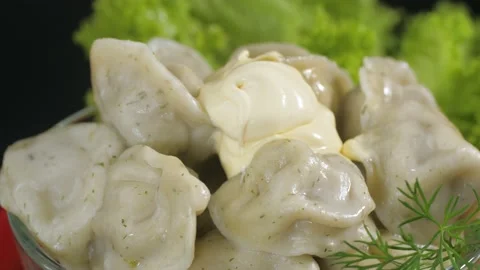 Dumpling dish with meat and sour cream in a glass plate. Stock-Footage 163764181