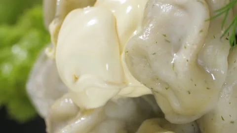 Dumpling dish with meat and sour cream in a glass plate. Video stock 234009383