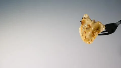 Dumpling on an edible fork on a white background Stock Photos