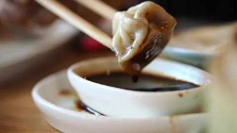 Dumpling served with sauce in a restaurant setting Stock Footage 341229174
