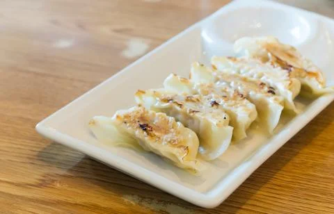 Dumpling on white dish on wood table Stock Photos