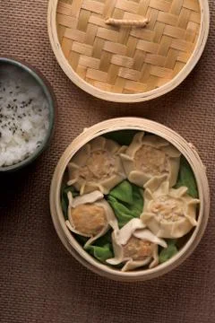 Dumplings and rice in baskets Stock Photos