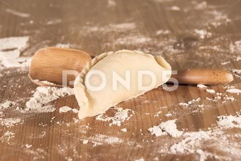 Dumplings and wooden spoon Stock Photos