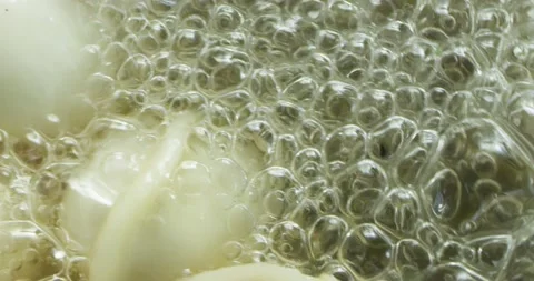 Dumplings are boiled in pot with boiling water with spices and spin on closeup Stock Footage 152101843