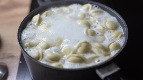 Dumplings cooking in boiling water. Stock Footage 330263740