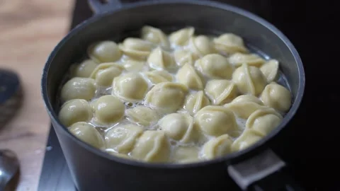 Dumplings cooking in boiling water. Stock Footage 330263783