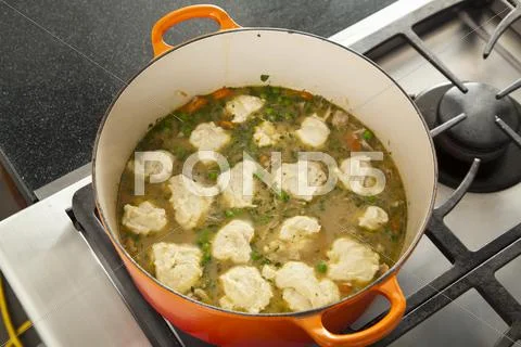 Dumplings Cooking in a Pot of Chicken Stew; From Above Stock Photos