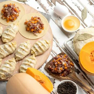 Dumplings Cooking process. Dough stuffed with minced raw meat and pumpkin Stock Photos