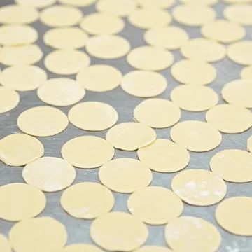 Dumplings, Cooking process. Rolling Raw dough pieces, perfectly even identical Stock Photos
