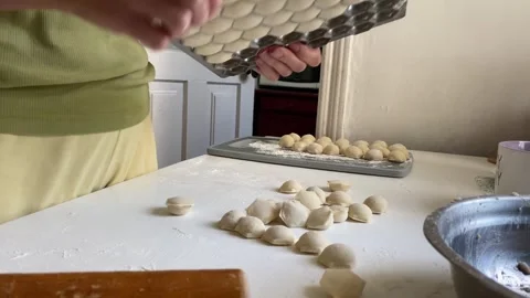 Dumplings Falling from Mold onto Table Stock Footage 315345893