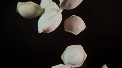 Dumplings fly up and fall down on a dark background. Stock Footage 282524878
