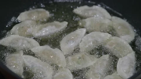 Dumplings fried in oil. Stock Footage 167237808