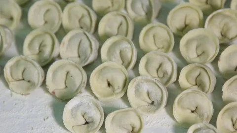 Dumplings with meat lie in rows on a tray Stock Footage 75255033