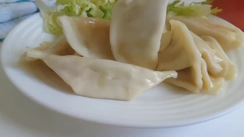 Dumplings on the plate fall, slow-motion shooting Stock Footage 87655674