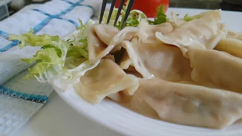 Dumplings, on a plate, fork Stock Footage 87829966