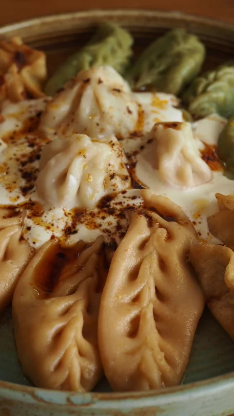 Dumplings served on a plate with different colors and shapes Stock Footage 336227020