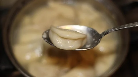 Dumplings in a spoon against the background of a pan Stock-Footage 122689082