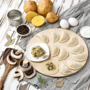 Dumplings stuffed with mashed potatoes and mushrooms. Cooking process. Filling Stock Photos