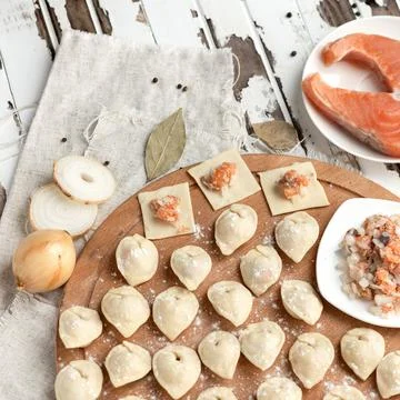 Dumplings stuffed with red fish, lean food cooking process. High angle view Stock Photos