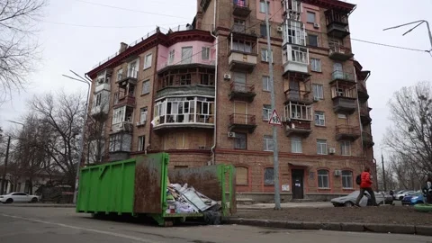 Dumpster with broken window frames in front of Ukrainian house Stock Footage 270162410