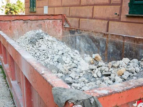 Dumpster container full of construction debris Stock Photos