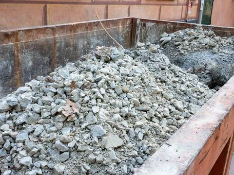 Dumpster container full of construction debris Stock Photos