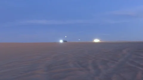 Dune Buggies racing across the screen in the desert Stock Footage 99158589