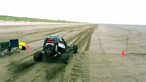 Dune Buggy Accelerates and Speeds Down Empty Beach Aerial Drone Footage Stock Footage 196983974