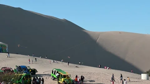 Dune buggy and kite flying at Huacachina Peru Stock Footage 163836981
