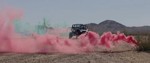 DUNE BUGGY CAR DRIVING THROUGH RED SMOKE FLARE Stock Footage 127474187