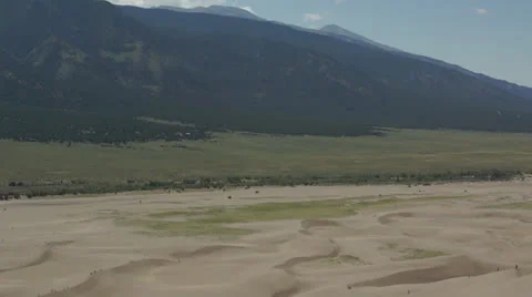 Dune surfer walking up ridge Stock Footage 26079391