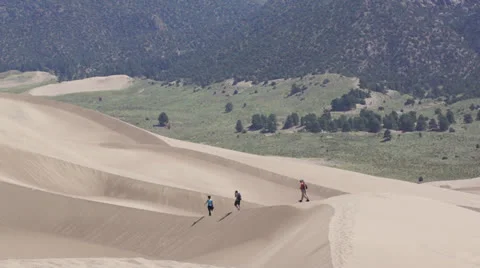 Dune trekkers on ridge Stock Footage 26078497