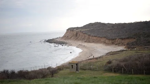 Dunes and cliffs off Montauk Point as waves reach the shore Stock Footage 70144625