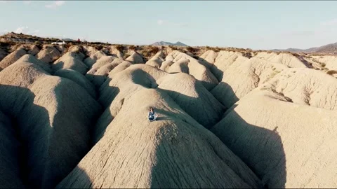 Dunes desert landscape drone point of view of woman on vacations at sunset Video stock 158542145