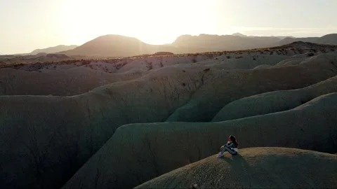 Dunes desert landscape drone point of view of woman on vacations at sunset Video stock 158542230