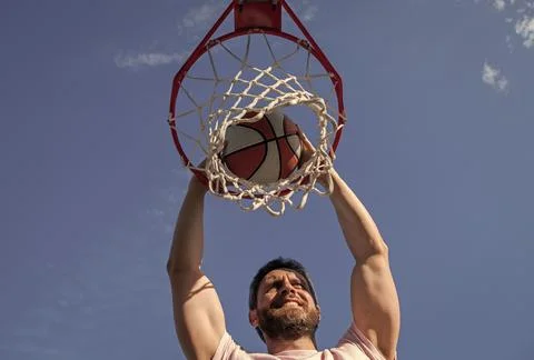 Dunk in basket. slam dunk in motion. summer activity. smiling man with Stock Photos
