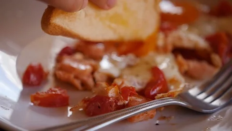 Dunk in yolk in fried eggs a piece of bread. slow motion, 1920x1080, full hd Stock Footage 90420879