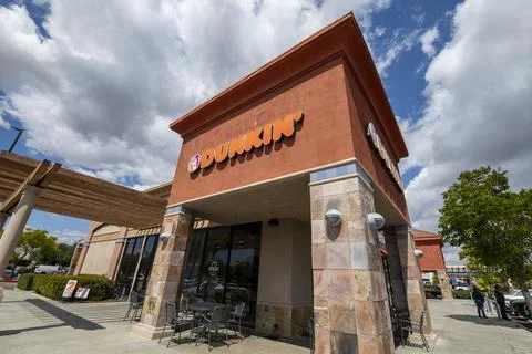 Dunkin Donuts store front, logo, sign, signage, marquees, entrance, clouds Stock Photos