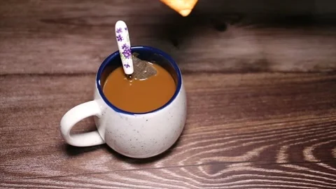 Dunking a biscuit into a cup of coffee Stock Footage 132532615