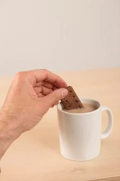 Dunking biscuit in tea Stock Photos
