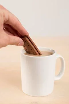 Dunking buscuit in tea 写真素材
