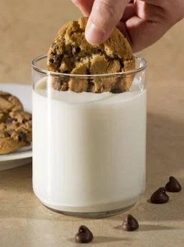 Dunking Cookie in Milk Stock Photos