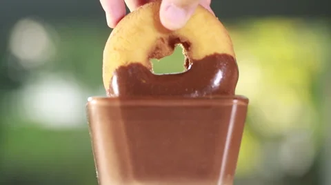 Dunking a donut into a glass of chocolate Stock Footage 51928355