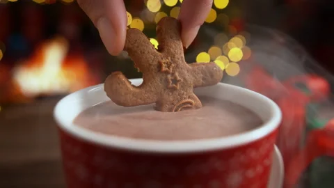 Dunking a Gingerbread Man Cookie in a Cup of Hot Cocoa in Slow Motion Stock Footage 208932077