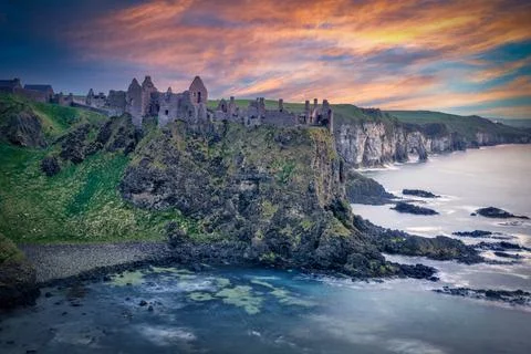 Dunluce Castle at Sunset  Dramatic Sky and Reflections on the Sea, Northern Stock Photos