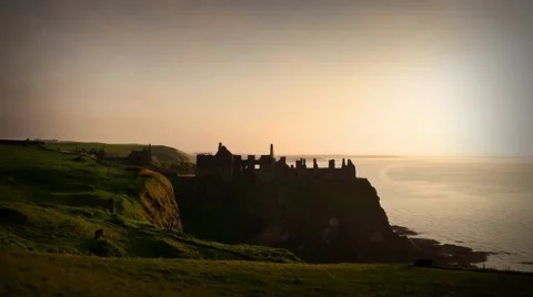 Dunluce Castle in warm evening light during sunset, Northern Ireland Video stock 64208559